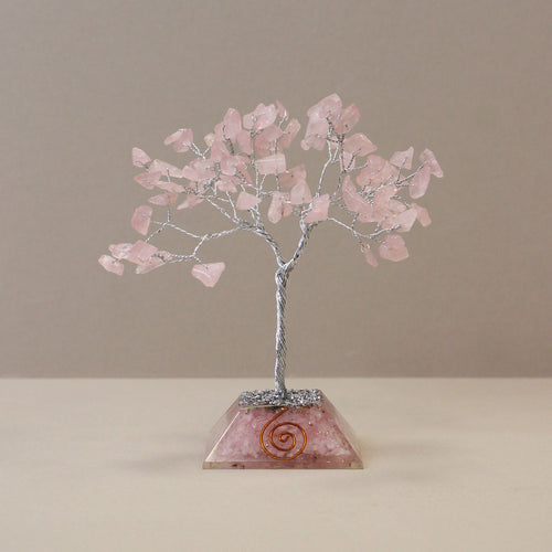 Apportez une touche douce et spirituelle à votre intérieur avec cet arbre en quartz rose avec socle en orgonite. Composé de 80 pierres naturelles, il séduit par son allure élégante, son esthétique minérale et son univers apaisant.