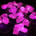 Guirlande lumineuse en quartz rose allumée, parfaite pour créer une ambiance douce, céleste et apaisante.