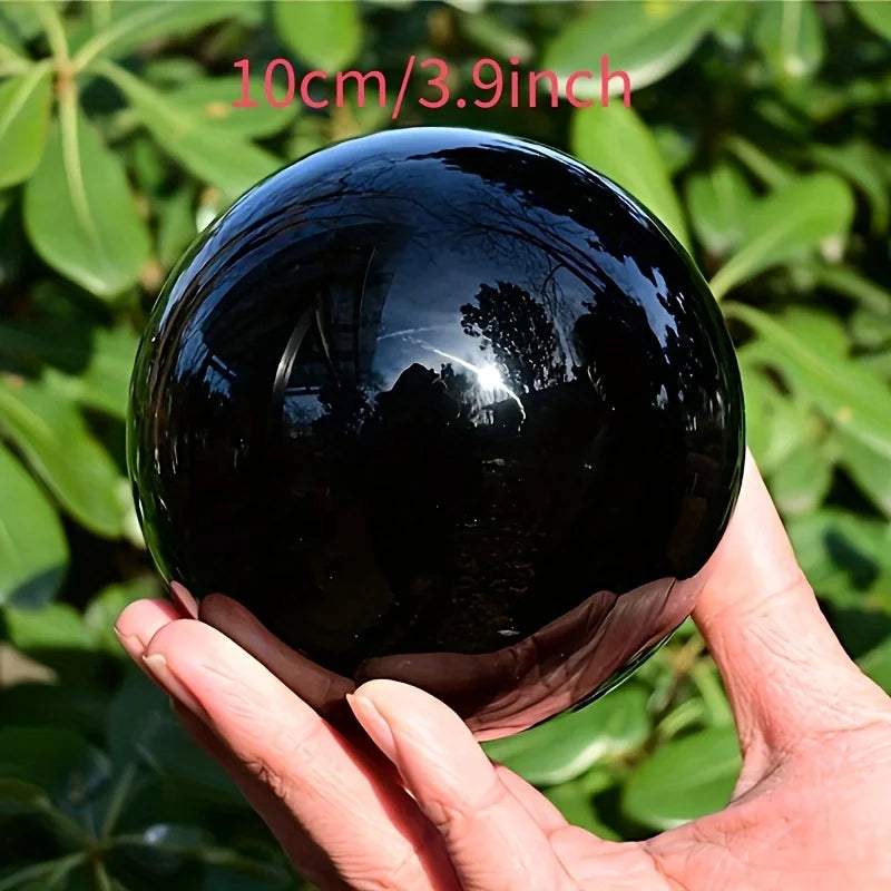 Sphère d'obsidienne noire naturelle polie – de 2 à 13 cm de 10 cm dans la main, reflet lisse et esthétique, idéale comme boule décorative minérale et objet spirituel.