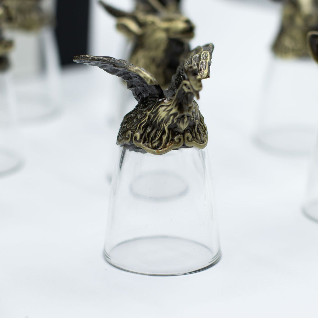 Focus sur un verre à shot en bronze antique avec une représentation d'un oiseau, dans le cadre des Bottom Up Shot Glasses (25ml). Ce lot de 12 verres à shot est parfait pour les accessoires de bar, promettant de rehausser toute collection d'arts de la table. C'est un cadeau original qui capte l'esprit du zodiaque chinois.